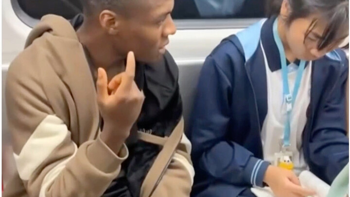 Black man harasses a female student on the subway
