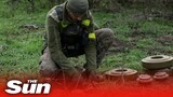 Ukrainian mine disposal team work to uncover and clear mines in Mykolaiv