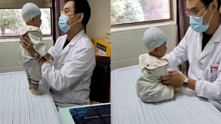 Cute kid gets repeatedly fussed over by a quality inspector, but stays calm throughout, eyes fixed o