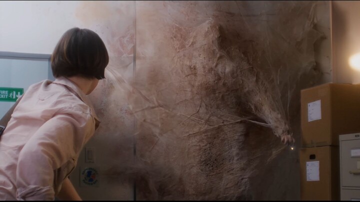 In the office, a flesh-and-blood wall oozes blood; when the woman finally sees what’s inside, she’s 