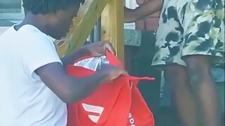 Delivery man eats fried chicken in front of black customer