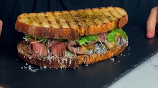 Tonight's late-night snack is: a super-thick sirloin steak, onion, and cheese sandwich 🧀🧅🥩