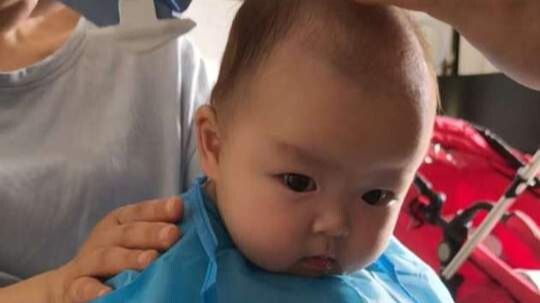 Baby’s first haircut, with bonus laughter from mom and auntie