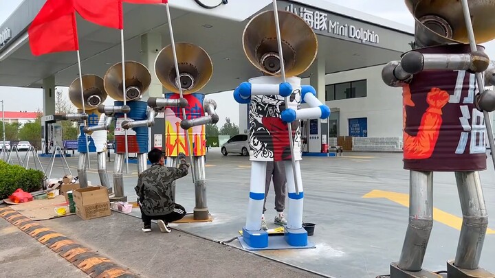 The colorful paint jobs on the six cheering robots are almost complete; now they’re ready to cheer y