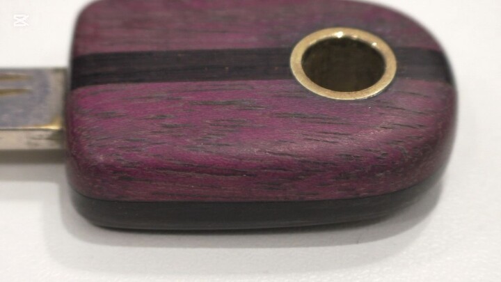 2. Wooden door key, made of purpleheart and dark brown bamboo, decorated with a brass rod, with a..