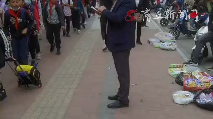 Elementary school principal stands guard, eyes glued to kids to stop them from buying junk snacks.