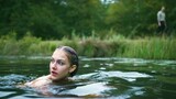 This Russian girl swims in the isolated lake, unaware of the danger lurking nearby!