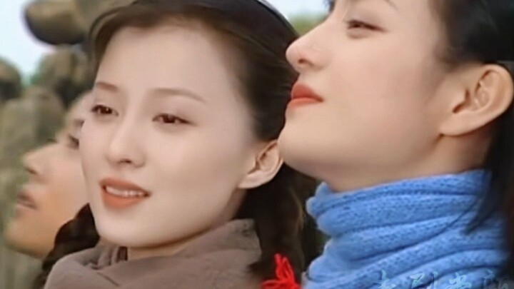 The camera pans, and a still more beautiful person appears beside the beauty.