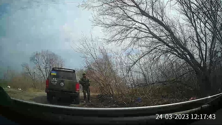 Ukrainian soldiers insult a muslim woman during a road control