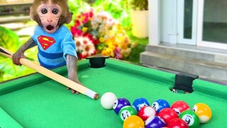 Bon Bon plays billiards in front of his house