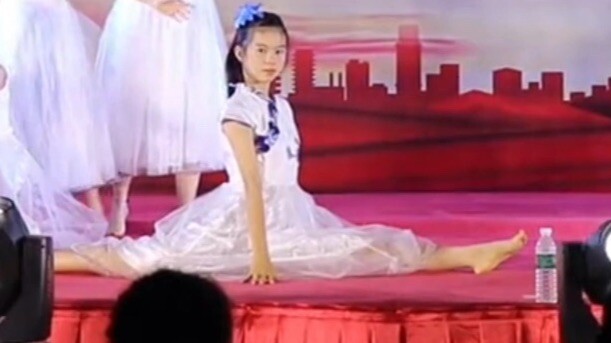 Middle school girls perform classical dance barefoot at a school gala