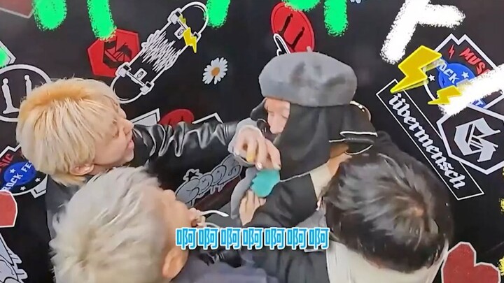 G-Dragon remains silent, simply shyly covering his face.
