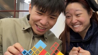 Watch couple playing with small building blocks