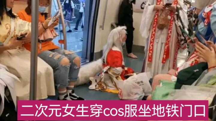 Perempuan dalam dunia dua dimensi mengenakan kostum cosplay di pintu masuk kereta bawah tanah
