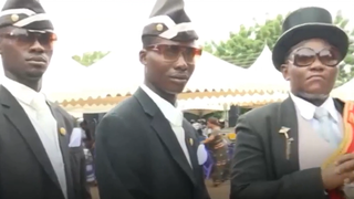 Black men carrying coffin