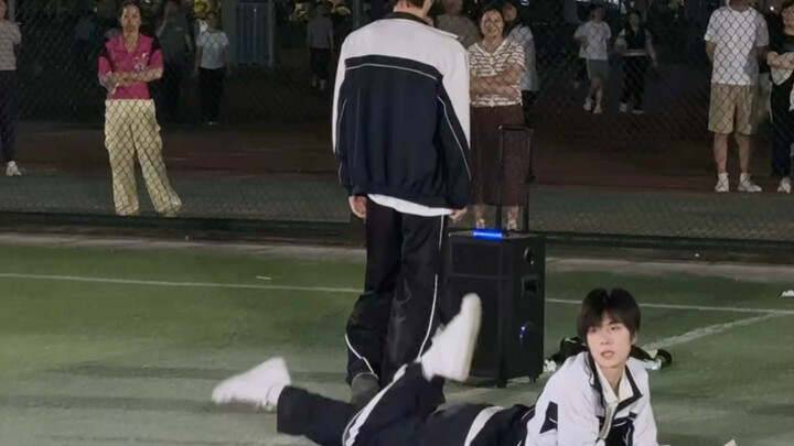 Male college student dances energetically on the sports field