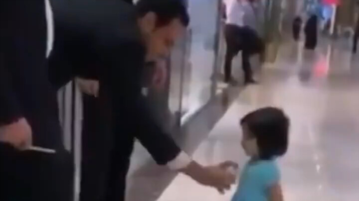 A little girl who wants to try the perfume her mom sprayed.