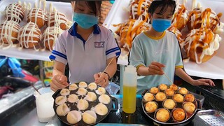 Hai nữ sinh làm bánh Bạch tuộc Takoyaki điêu luyện đơn giản tròn như bóng Golf ở đường phố Sài Gòn