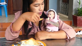 Today Cute Tiny boy Maki Happy Enjoying Eat Bread Fried And Drinking Milk With Mom For Breakfast