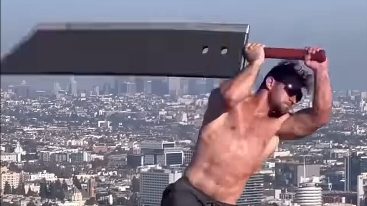 This man is trying to wield a giant sword.