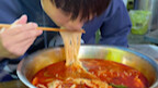 This handsome guy from Henan is taking on a five-liang serving of snail rice noodles in the freezing