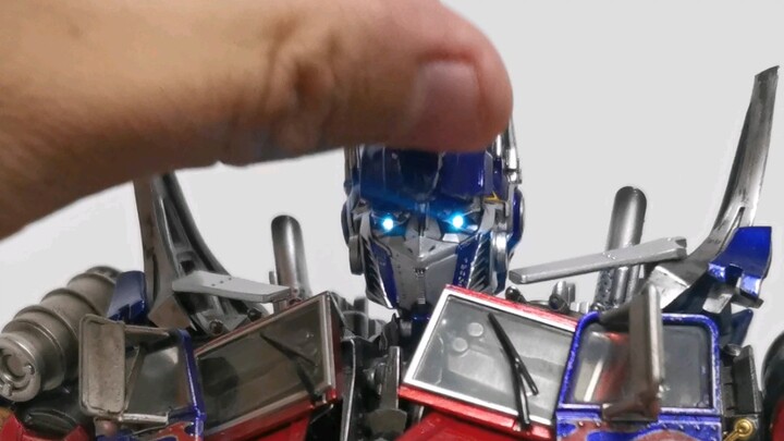 A little bit high... Touching Optimus Prime's head with a smile