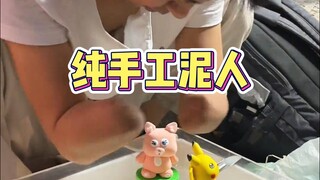 The handmade clay figurine of the armless street brother, the lovely Lingna Belle, pays tribute to e