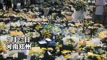 Flowers are laid out in front of Shakou Station on Zhengzhou Metro Line 5; survivors choke back tear