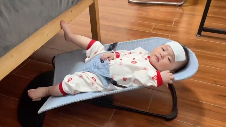 A self-amused baby insists on playing even with a slight fever!