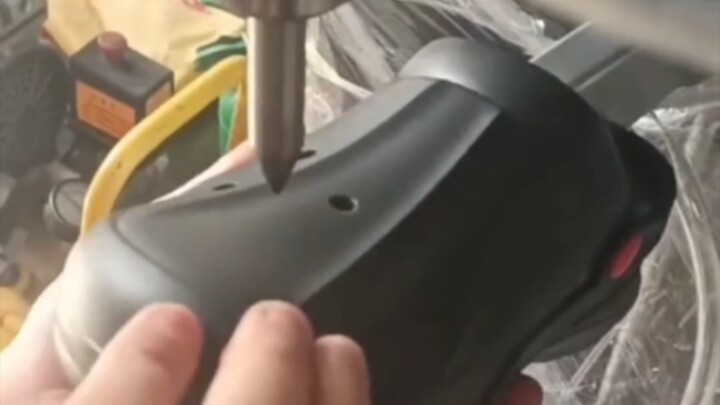 The job is poking holes in Crocs.