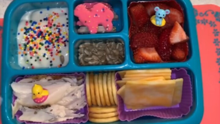 American woman prepares lunch for her child, who is so hungry that he chews on his classmates