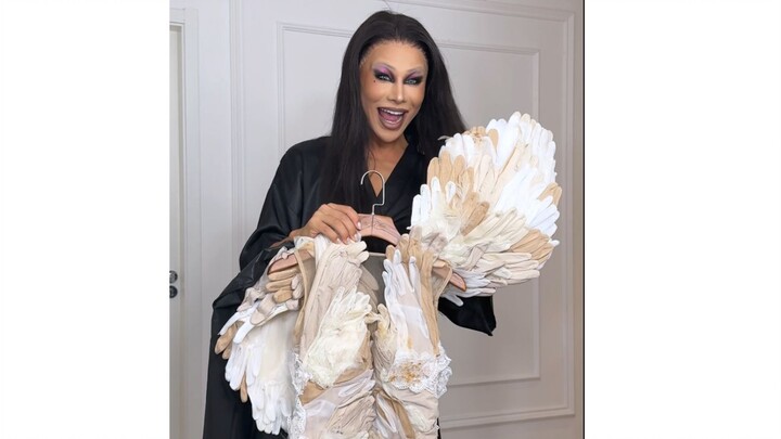 Challenge: Trying on a feather coat made from hundreds of pairs of gloves!