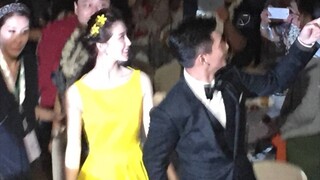 The wedding dinner with a few small yellow flowers and a small yellow dress became the hit and white