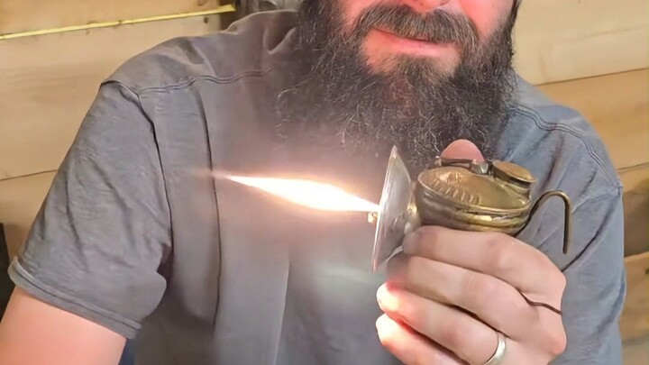 Why can an old-fashioned mining lamp be lit by simply rubbing it with your hands?