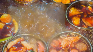 A family photo of spicy hot pot at a roadside stall. Guess how much it costs for a string of each?