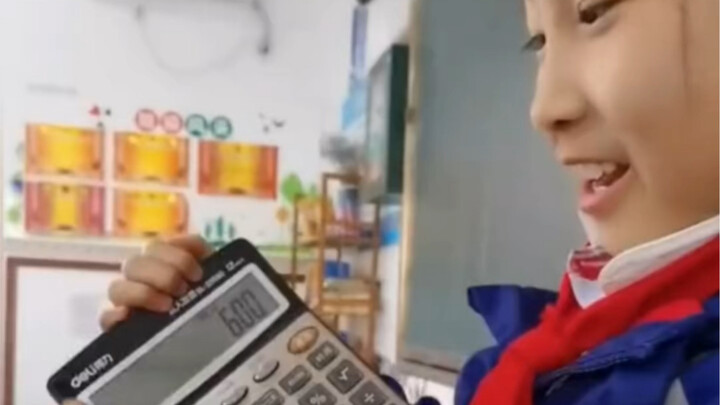 Little girl performs a magic trick for her teacher: turning the number 6 on the calculator into 9!