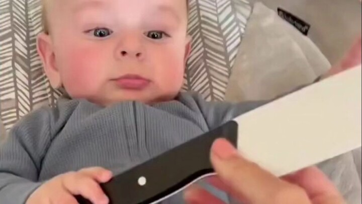 Let the baby grab a pretend knife and prank the family—see how they react: