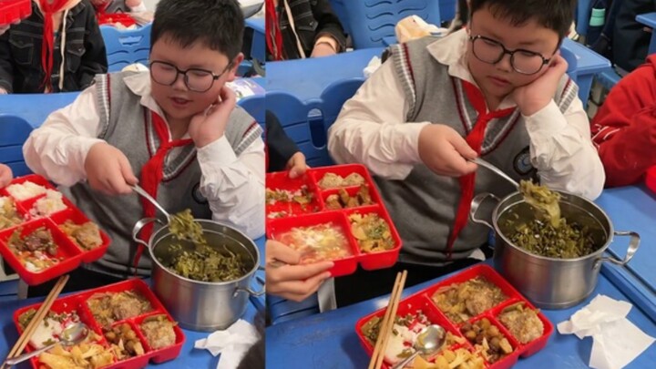 男孩将妈妈做的饭菜和同学分享，身后女同学的举动亮了