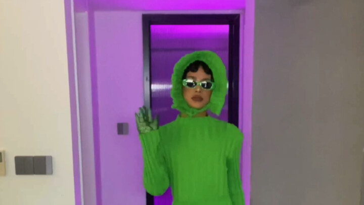 Boy does Cardi B–inspired makeup at home; the green “baby” scares the family dog to death.