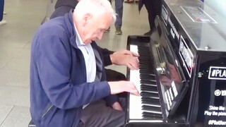 Elderly man wows the crowd with his piano skills by the roadside