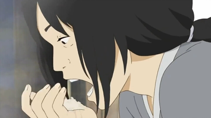 The woman lifted the lid of the pot, scooped up half a handful of uncooked rice and stuffed it into 