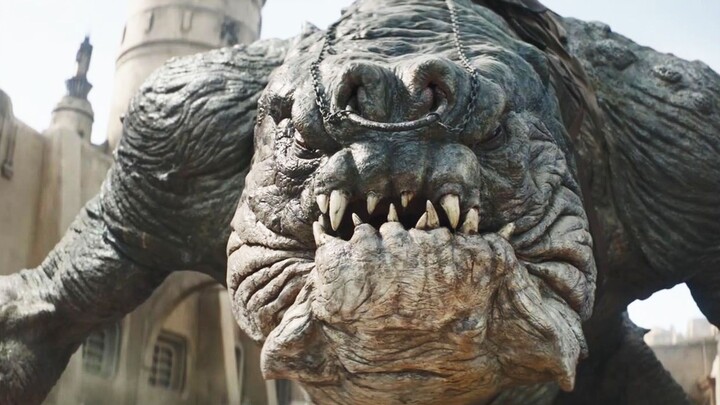 An alien behemoth as big as a mountain rampages, destroying city buildings—while a giant mecha rips 