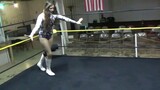 Women wrestling low blow