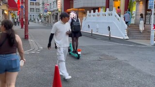 Japanese girl with black silk scooter, the most beautiful boy on Chinatown