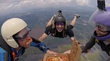 Four skydivers eating pizza at an altitude of 4,200 meters