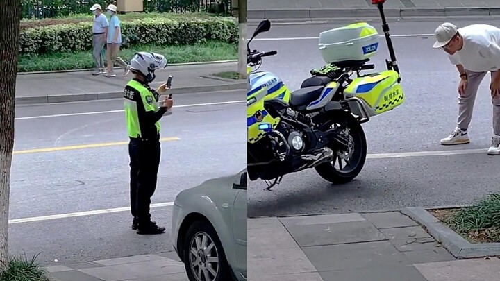Traffic police was busy issuing tickets, but the man stared at his motorcycle and liked it more and 