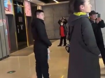 February 28, Heilongjiang: A man delivers a passionate speech outside a cinema.