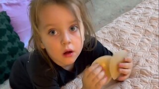 The cute baby plays with his aunt's breast sticker and asks what it is