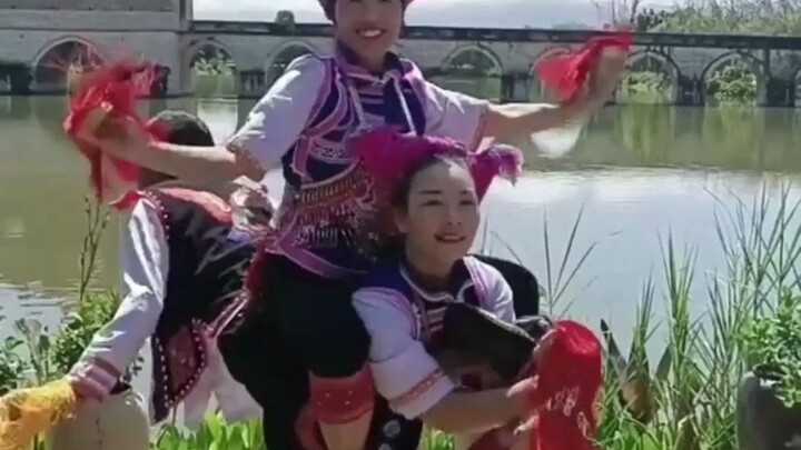 Yunnan's intangible cultural heritage "Smoke Box Dance," three performers demonstrate one of its mov