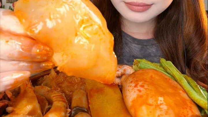 A little girl with a crispy, spicy seafood platter who can’t be bothered to think of a title